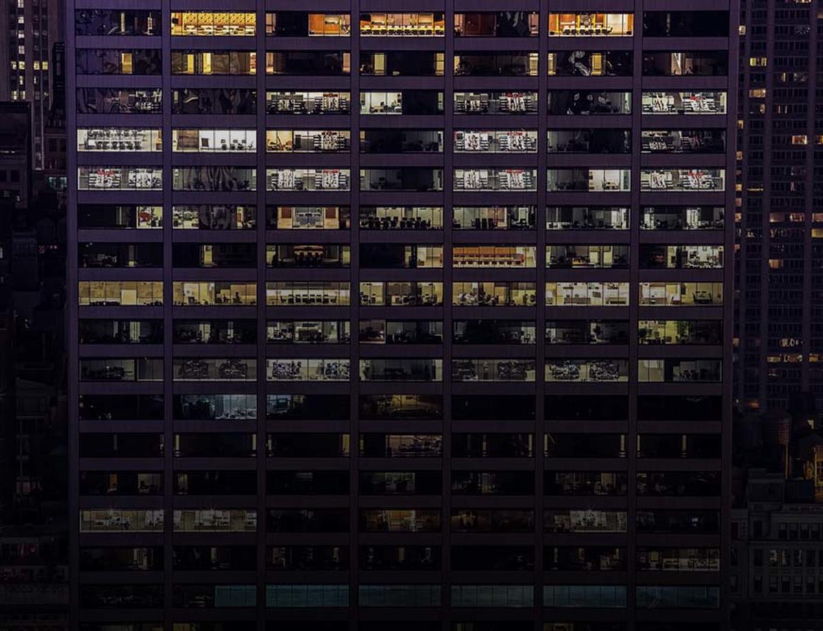 Window wall of a large office building at night
