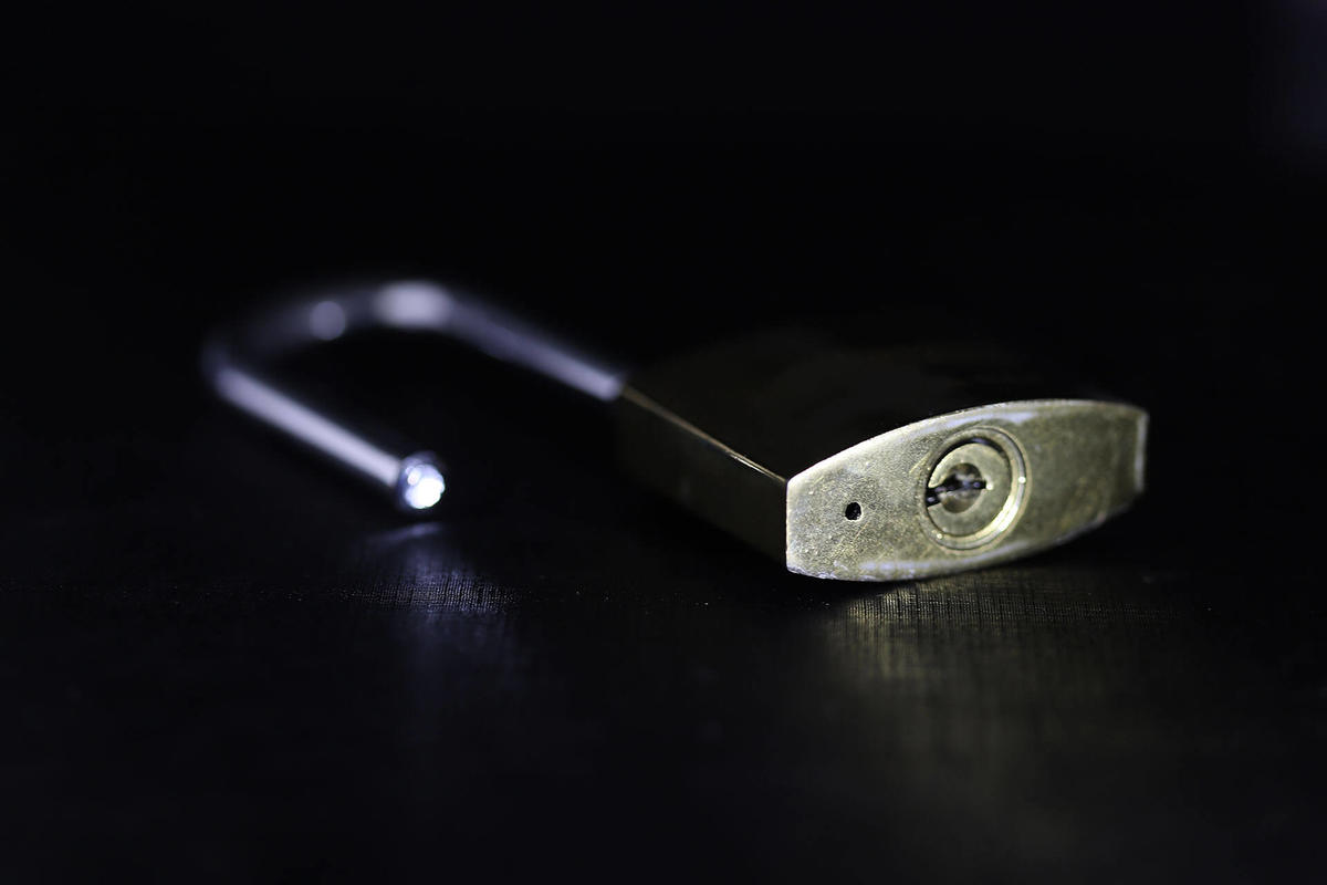 Close-up image of padlock with a dark background