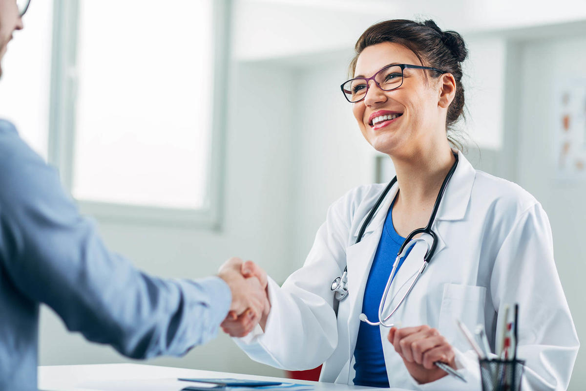 Woman working in the healthcare industry shaking hands with a customer